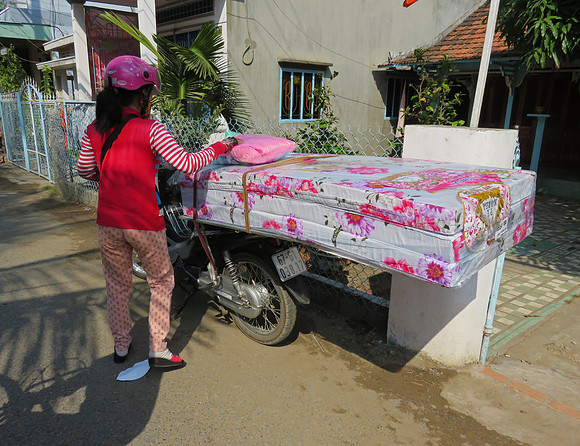 Transporting a mattress in Tan Chau