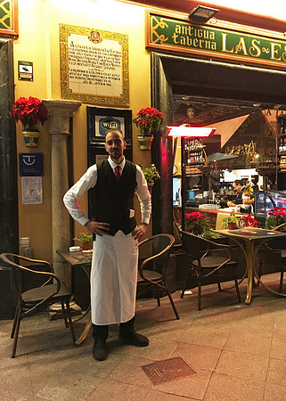 Waiter outside restaurant in Cordoba, Spain